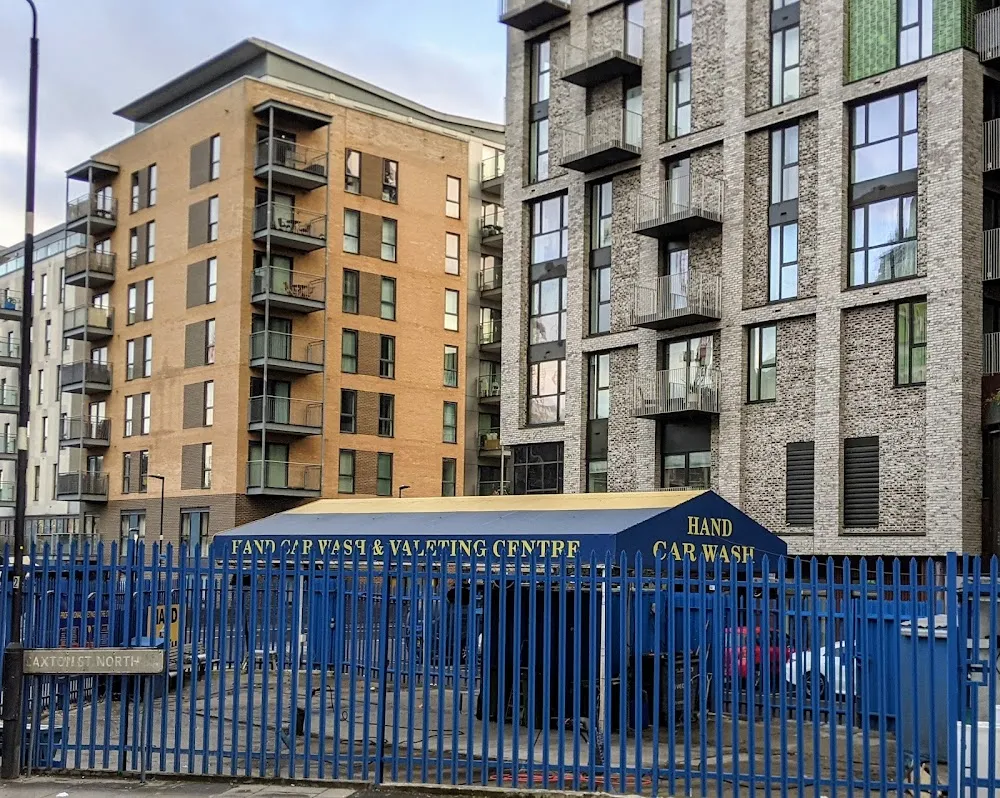 The hand car wash and valeting centre on Caxton Street North, fenced off in front of surrounding residential tower blocks